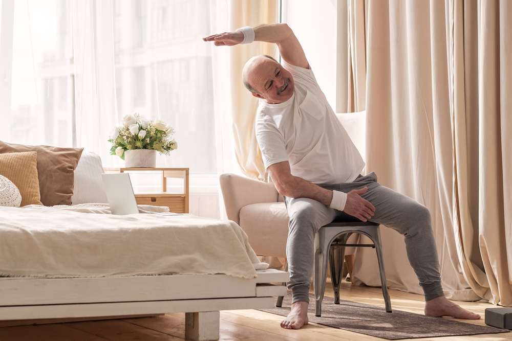 senior man exercising in chair
