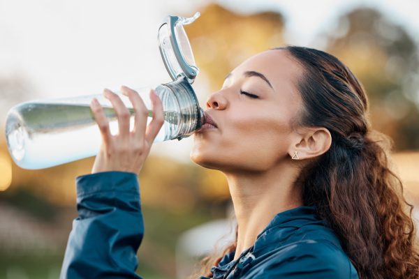 A woman drinking water for optimal hydration