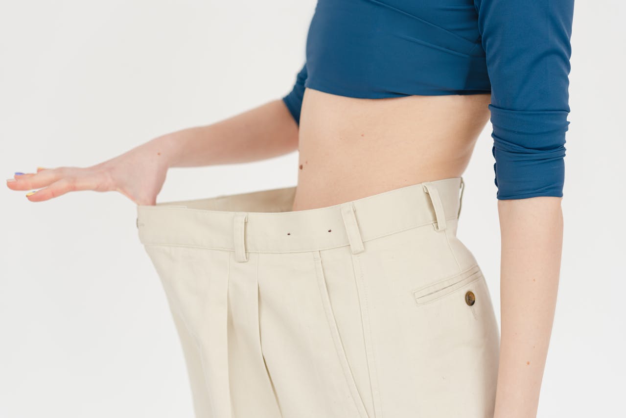 Photo by SHVETS production: https://www.pexels.com/photo/crop-woman-in-oversized-pants-6975481/